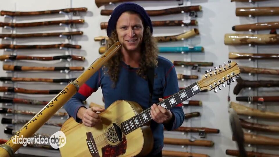 Nathan Kaye playing the didgeridoo and guitar together